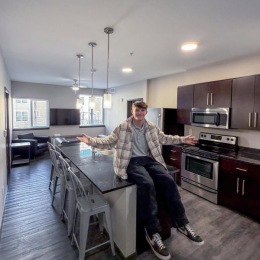 a person sitting on a table in a kitchen