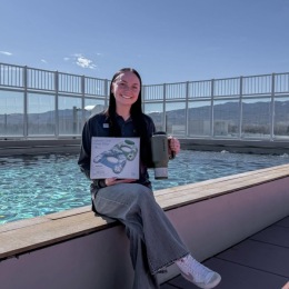 a person sitting next to a pool