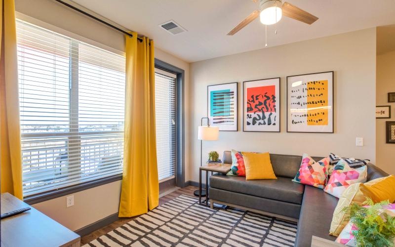 a living room with a couch and a fan